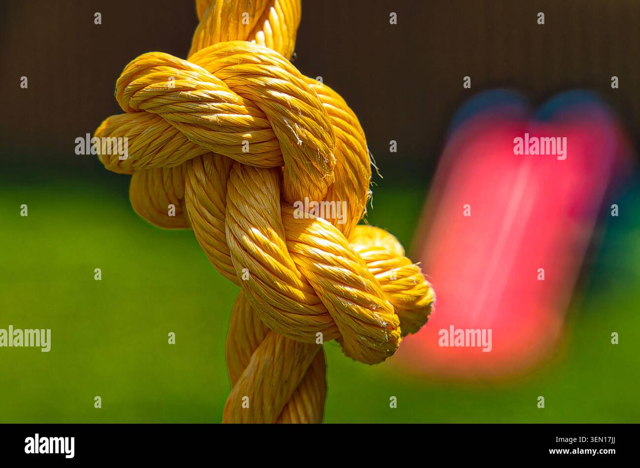 Yellow polypropylene rope with a complex knot Stock Photo
