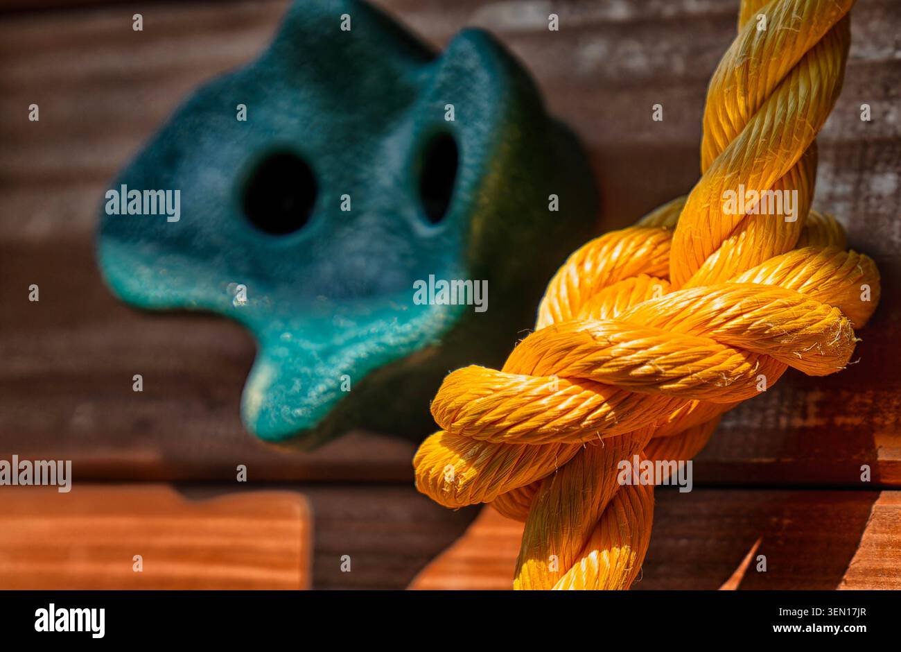 Yellow polypropylene rope with a complex knot Stock Photo