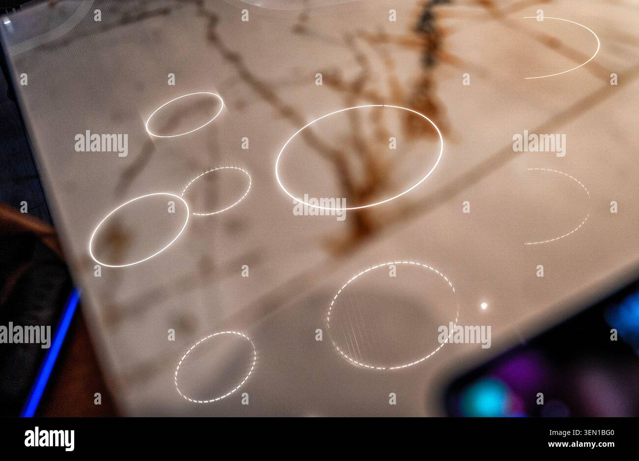 Ceiling lighting reflected onto a marble countertop Stock Photo