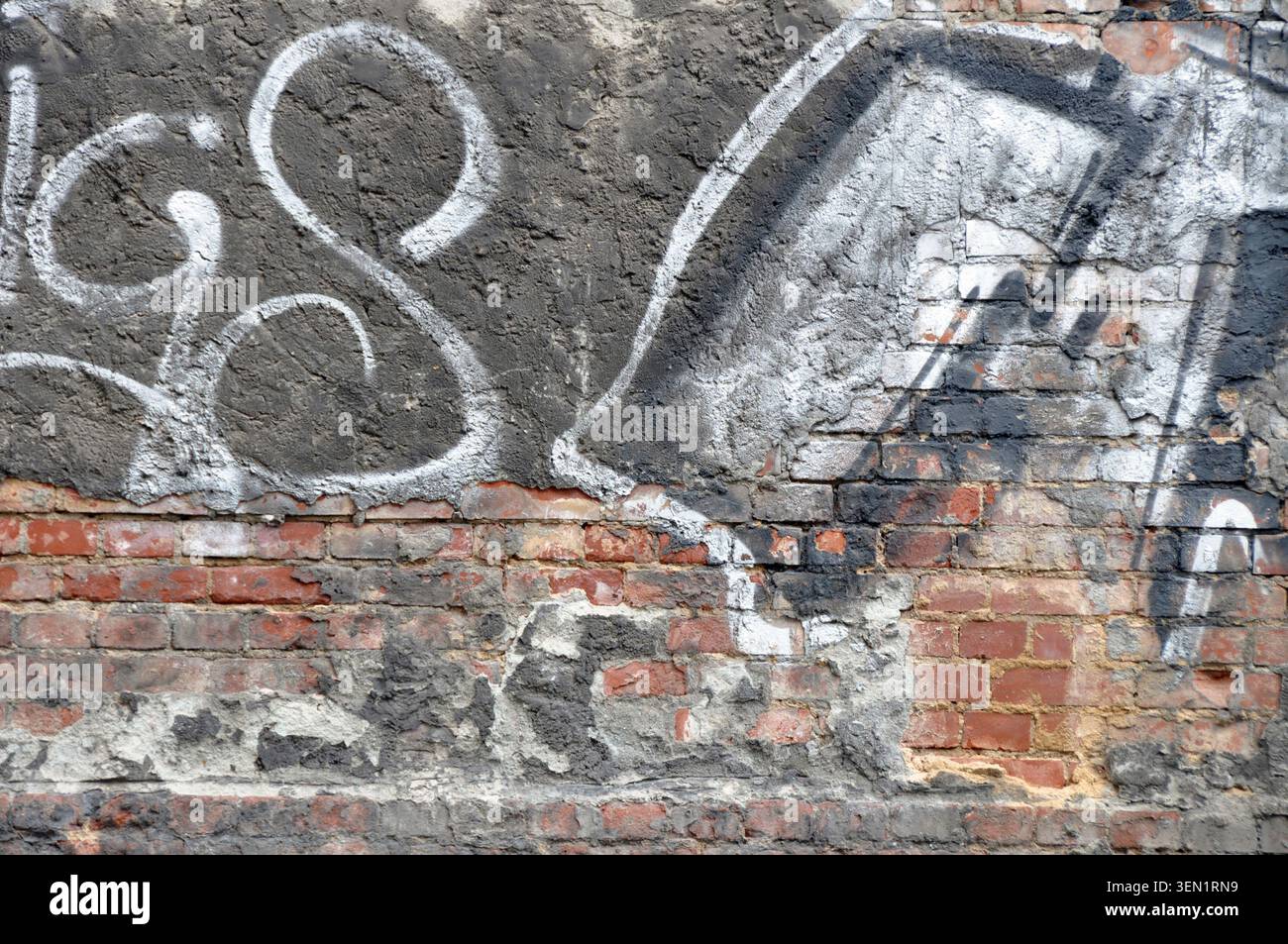 Graffiti on house wall with bricks Stock Photo
