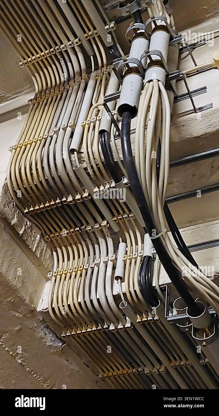 Angled, surface-mounted electrical installation with empty conduits and cable terminals Stock Photo
