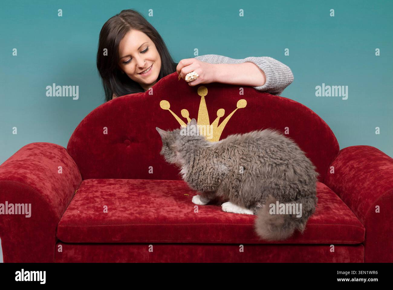 Young woman with Devon Rex tomcat Stock Photo