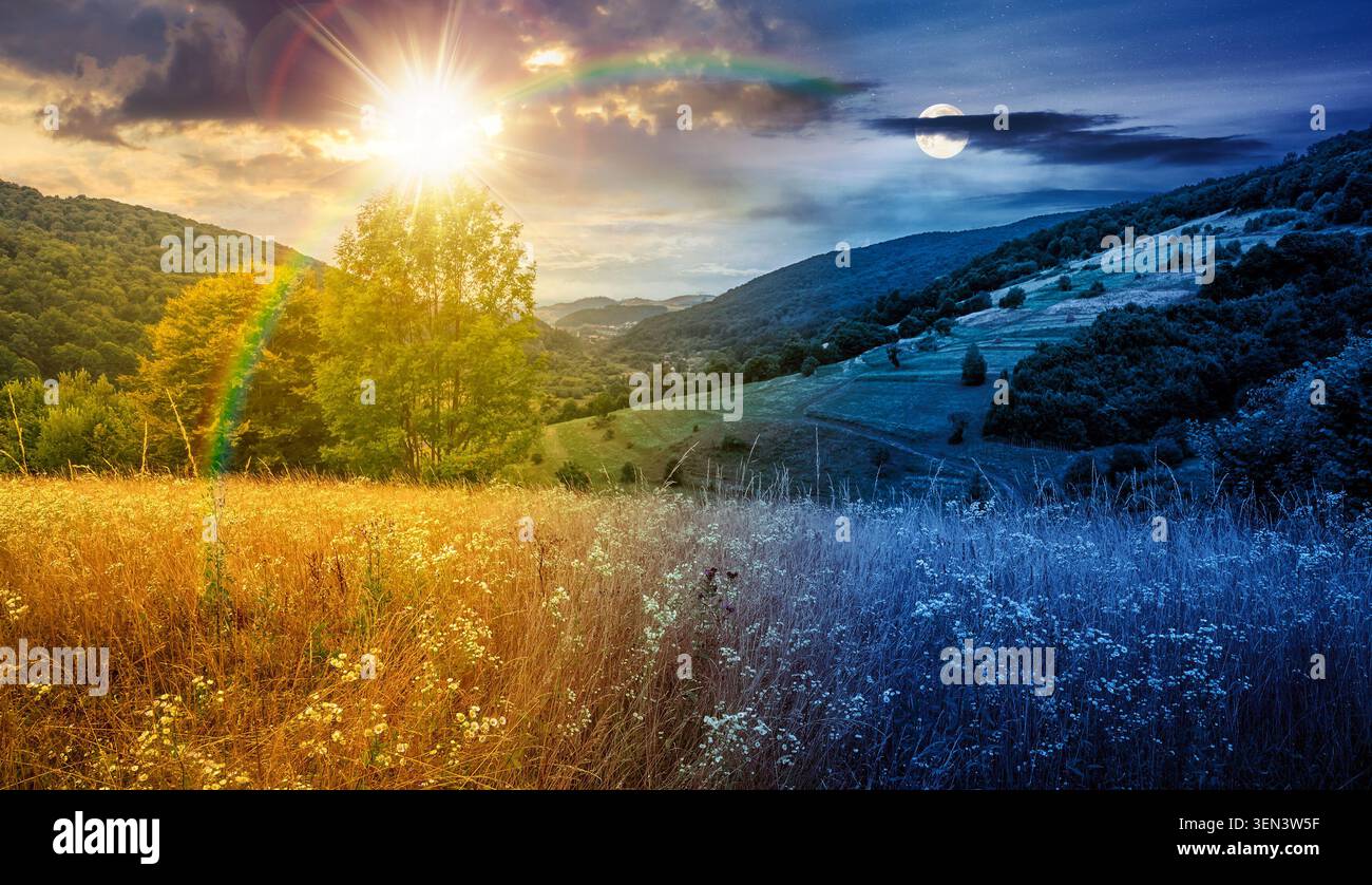 rural field on the hill. time change concept. view in to the valley at twilight. sun and moon over countryside mountain landscape. alpine pasture near Stock Photo