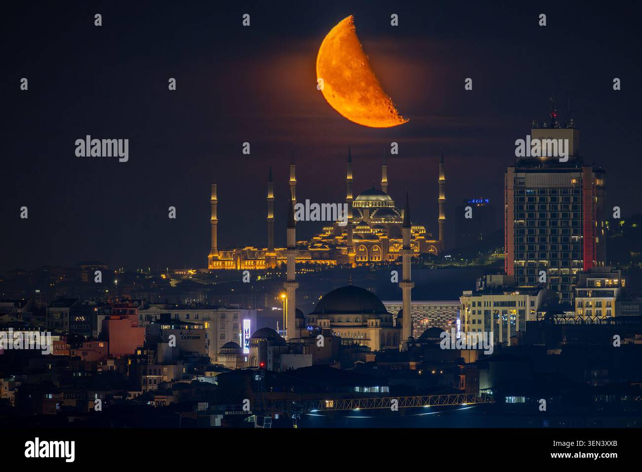 The moon rises over Taksim Mosque and Camlica Mosque, creating a ...