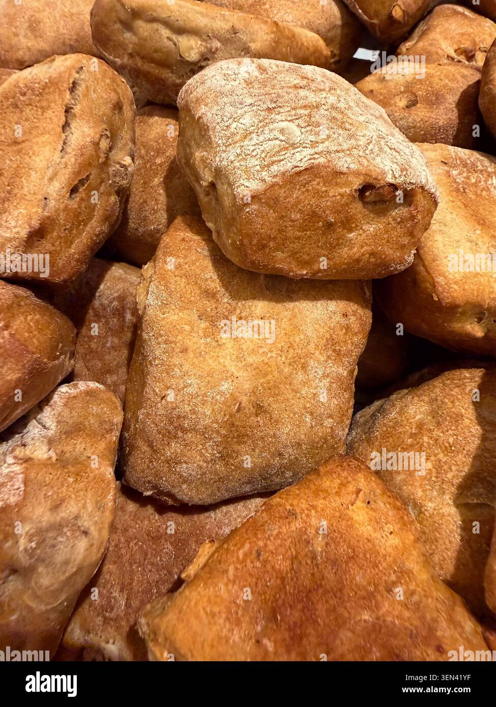 Rustic ciabatta rolls piled in a bakery display Stock Photo