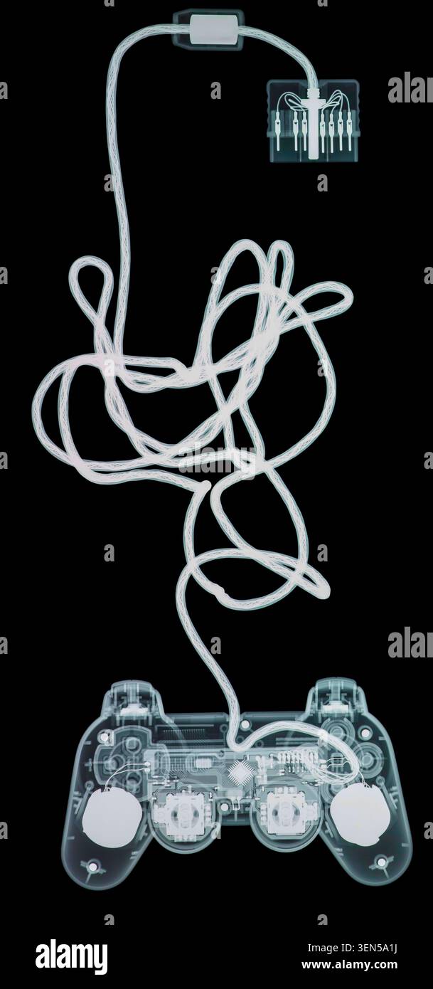 X-ray of a games console controller, showing joysticks, buttons and wire connection. Stock Photo