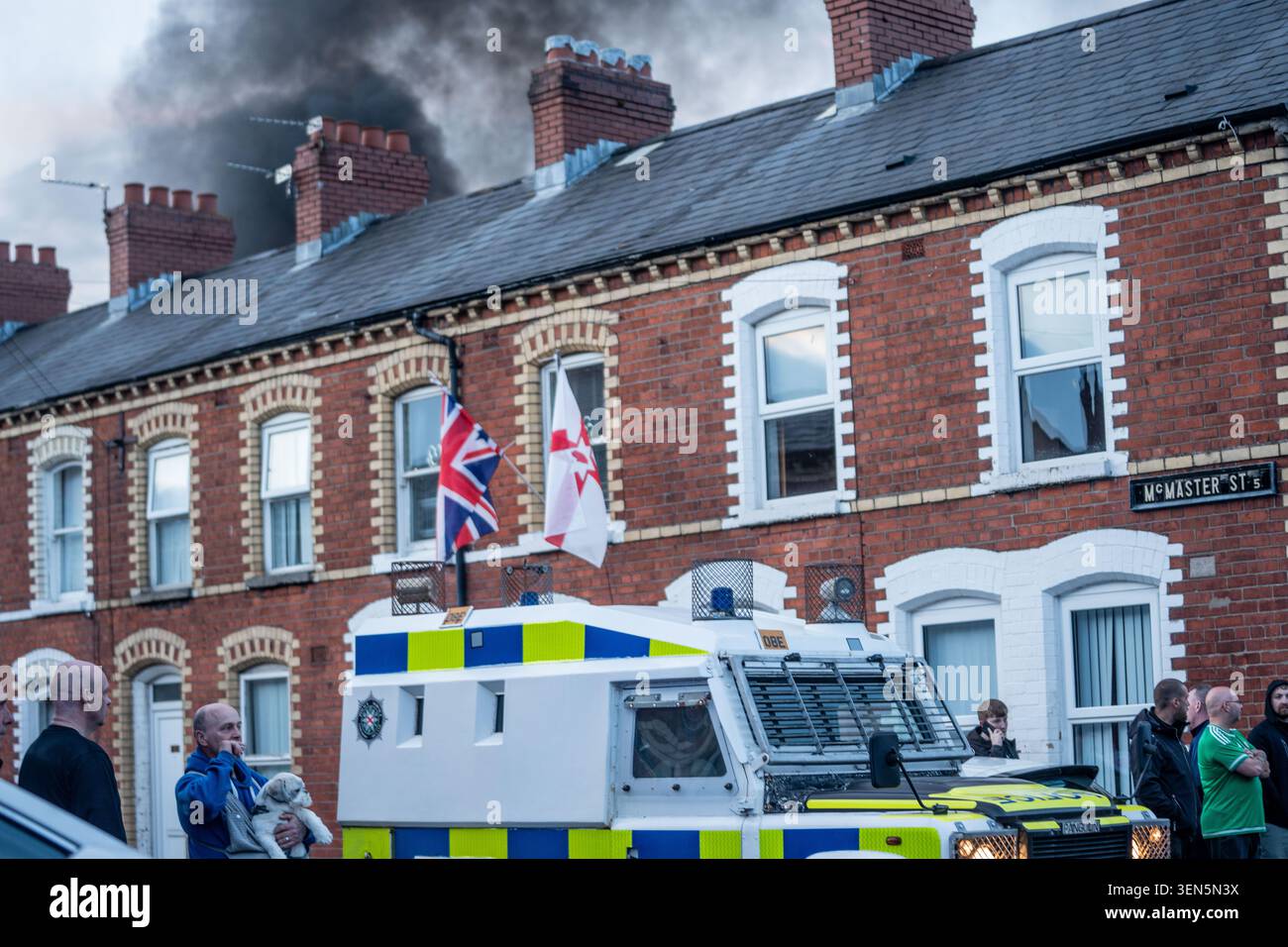 Belfast, UK. 09th June, 2026. Riot Police arrive at the scene of a fire lit by anti-immigration protestors in Belfast. Belfast erupted into flames as locals took to the streets to protest against the stabbing of a North Belfast man by a Sudanese national refugee. Road blockades were set up all over Belfast bringing much of the city to a standstill. The protestors are demanding a stop to immigration into Northern Ireland. Credit: SOPA Images Limited/Alamy Live News Stock Photo