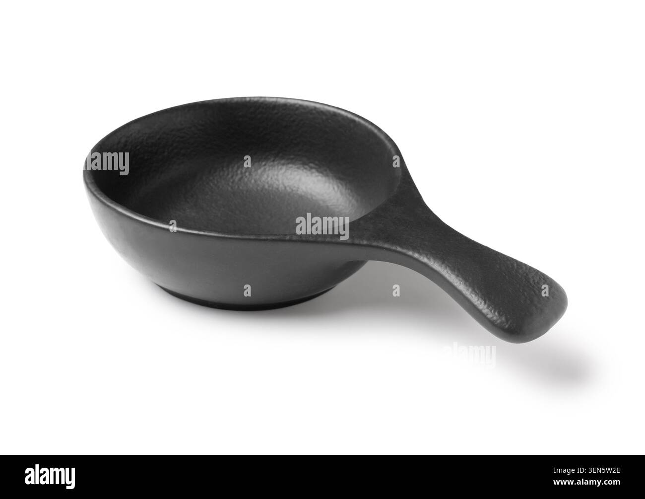 Empty black ceramic sauce dish with handle, modern kitchenware for culinary presentation, isolated on white background Stock Photo