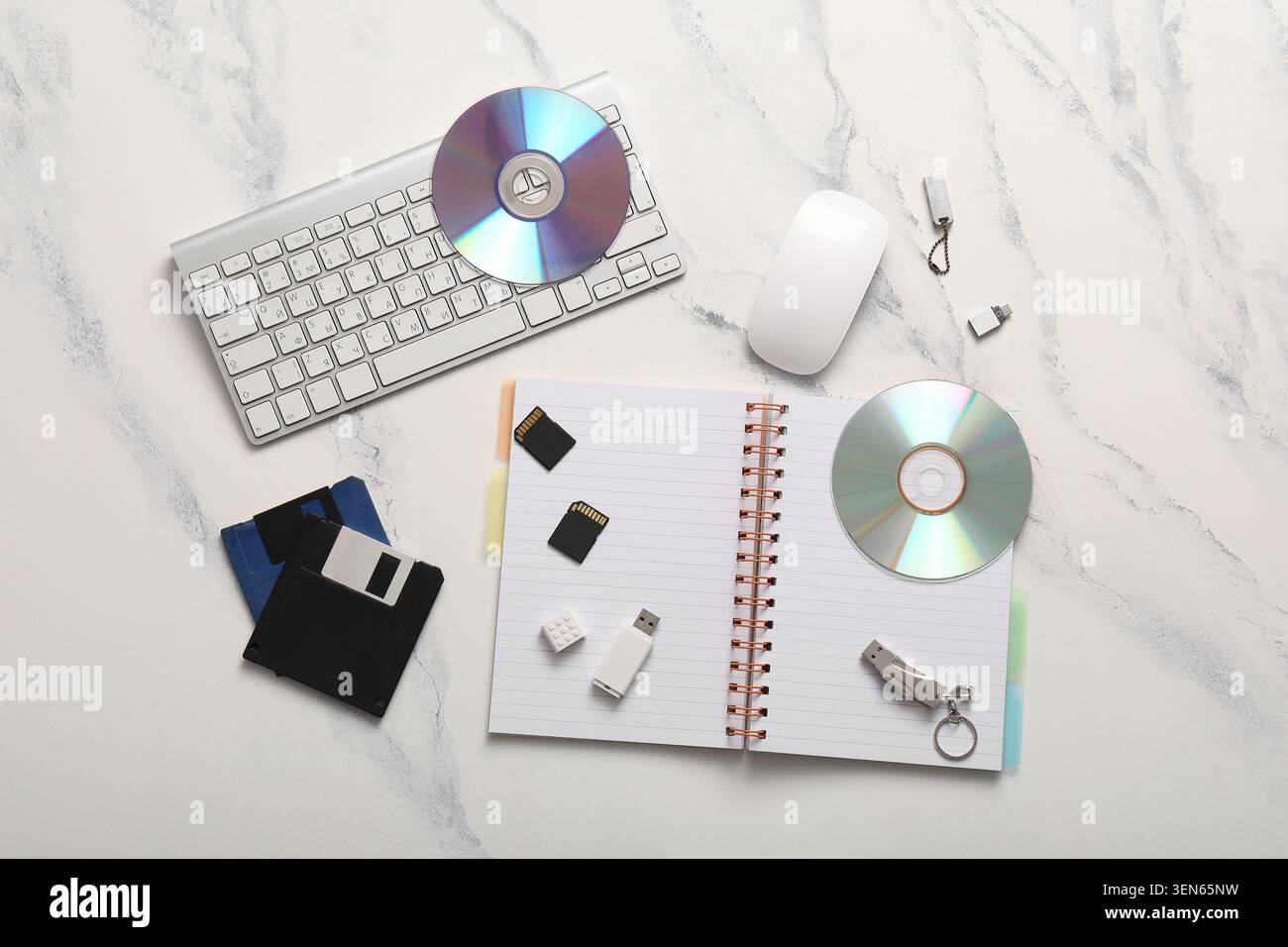 Digital data storage devices and computer peripherals on white marble background, technology evolution and information management Stock Photo