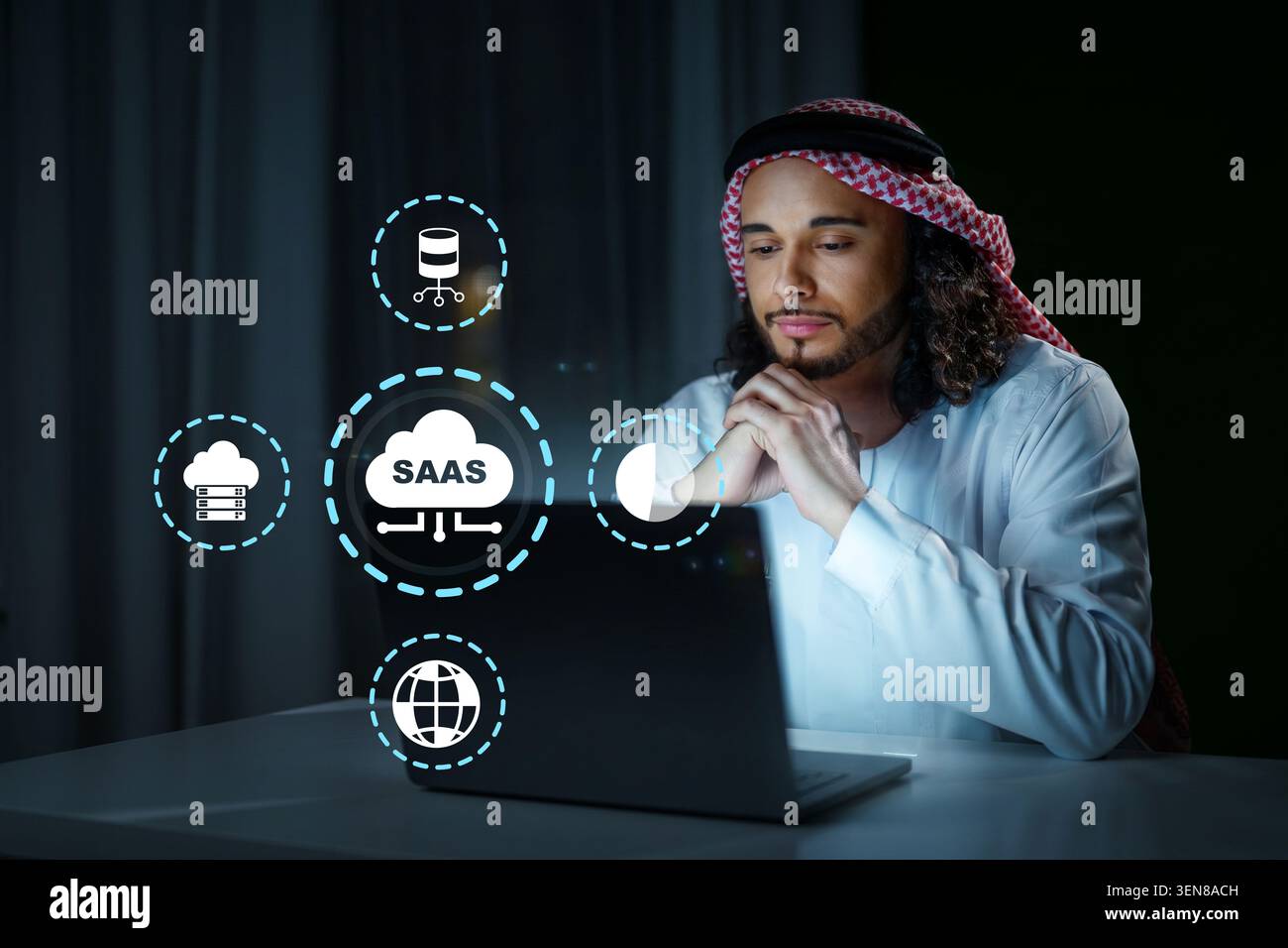 Person using laptop to explore software as a service solutions at night Stock Photo