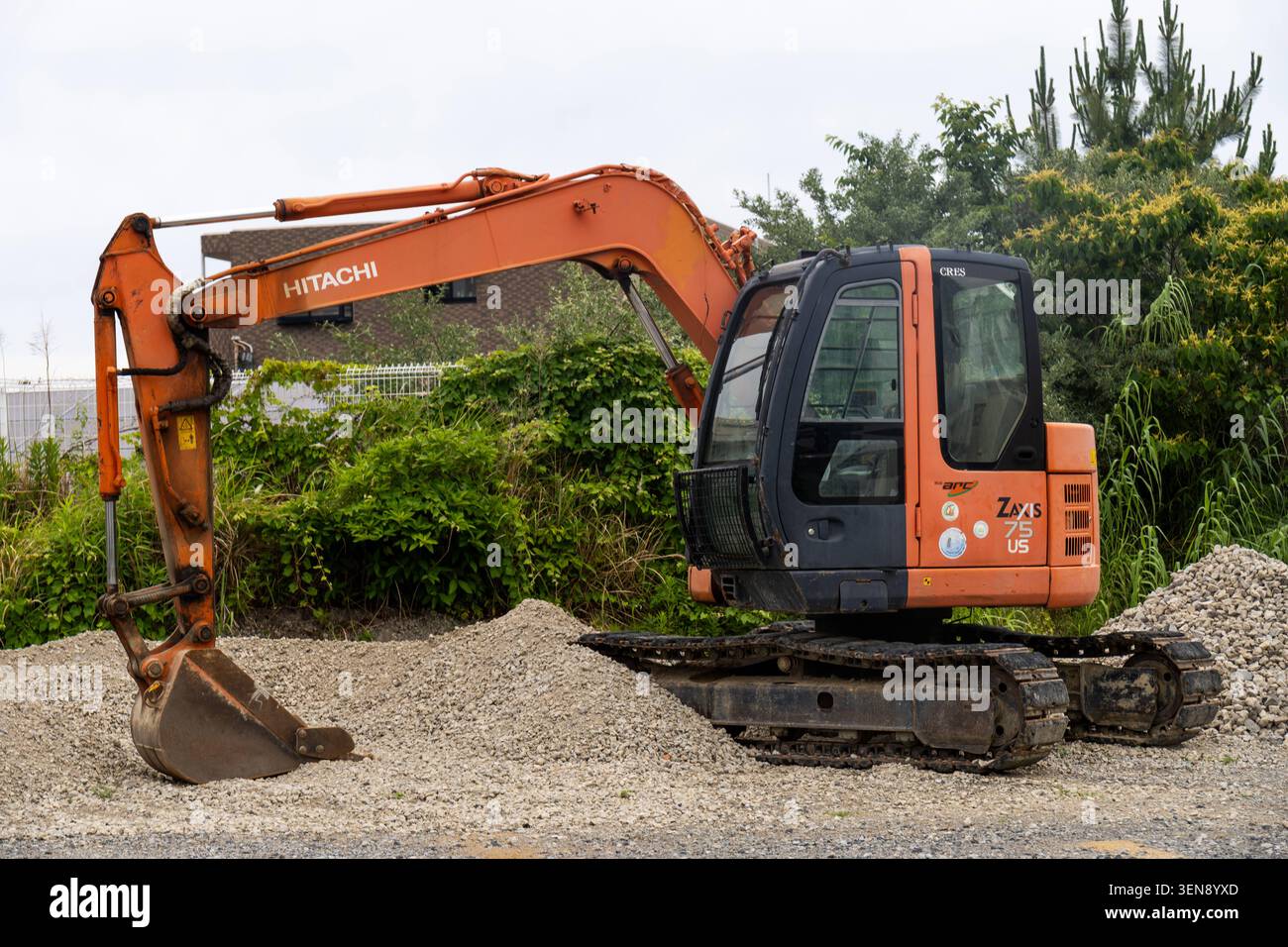 Compact Earthwork Shirahama, Japan May 31, 2026: A Hitachi compact excavator on a gravel ...