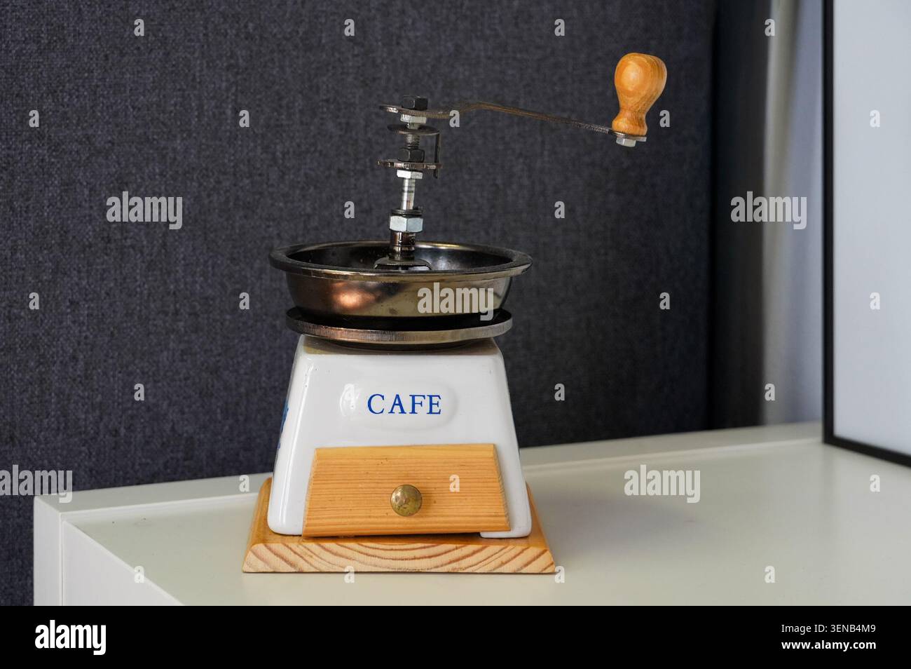 Coffee grinder with the word coffee on a white table Stock Photo