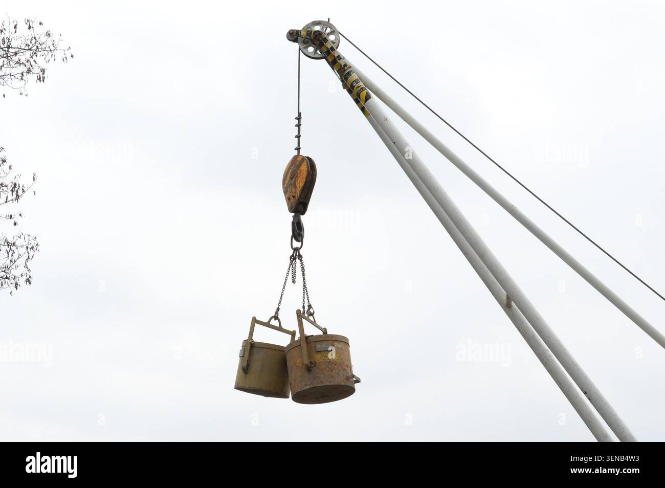 Crane hook with bucket, close-up, low angle view Stock Photo