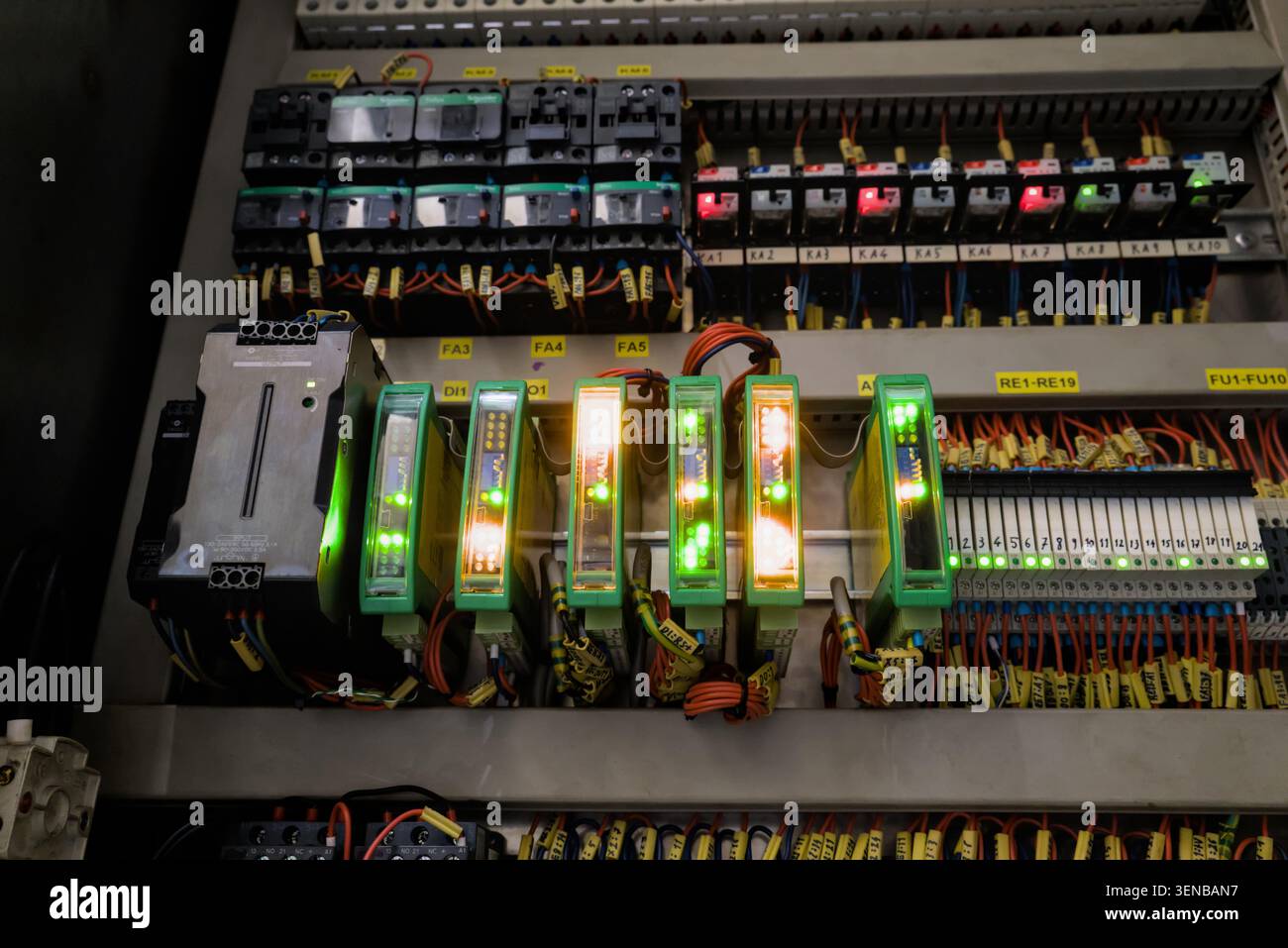 Programmable logic controller system with communication modules operating in normal status inside electric cabinet Stock Photo