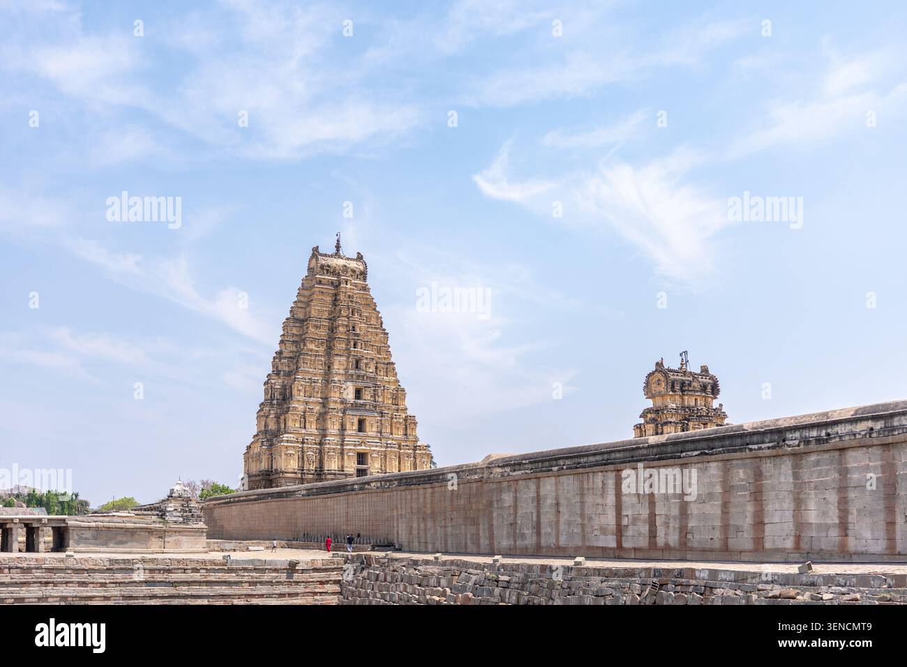 Hampi, India - March 13, 2025: Majestic Gopuram and Temple Wall Under ...