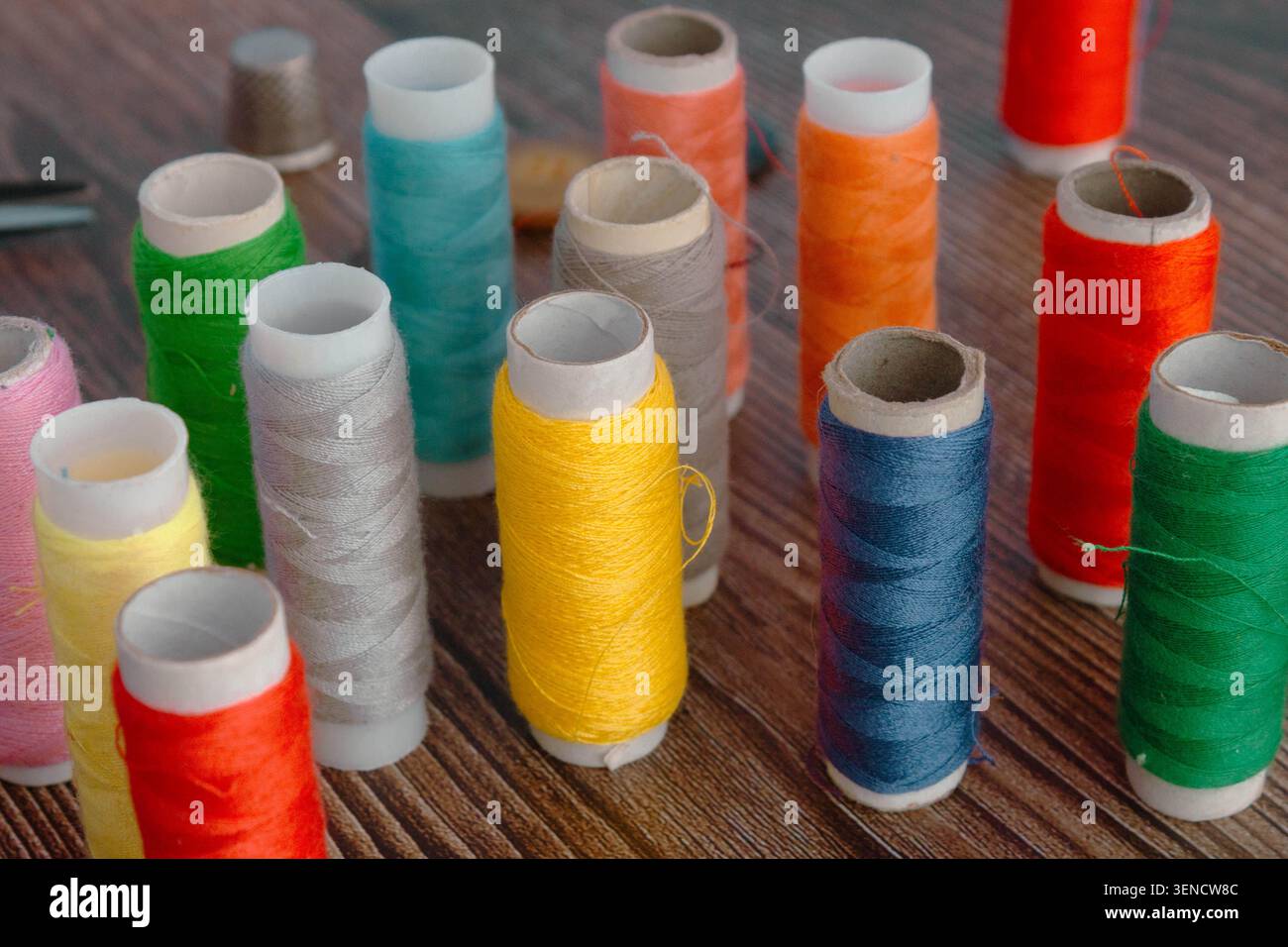 Colorful Sewing Thread Spools On Wooden Table Stock Photo