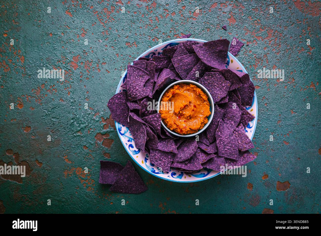 Violet tortilla chips with red salsa Stock Photo