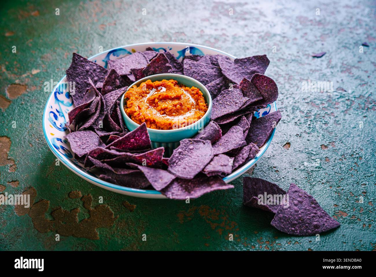 Violet tortilla chips with red salsa Stock Photo