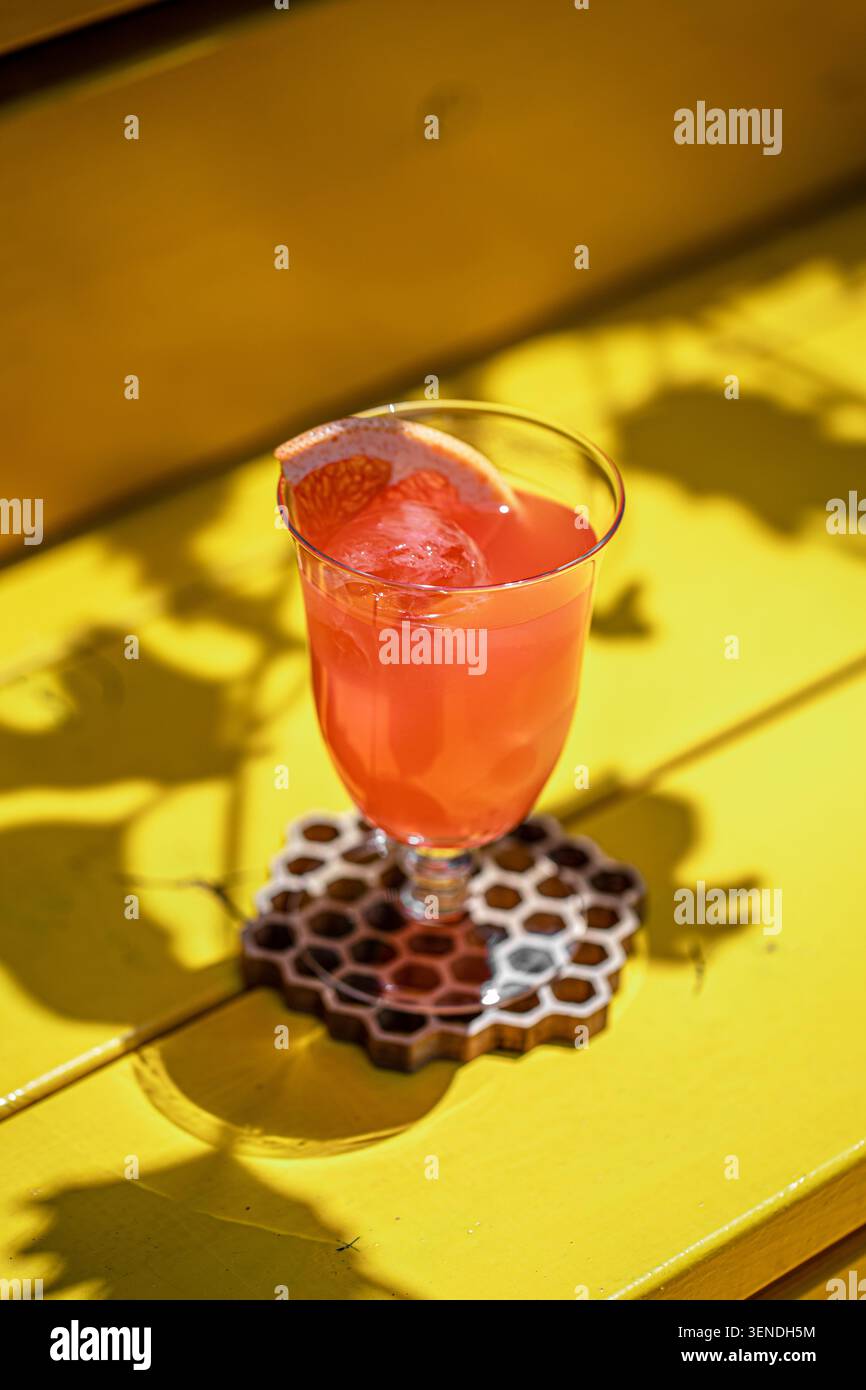 Grapefruit cocktail on bright yellow table Stock Photo
