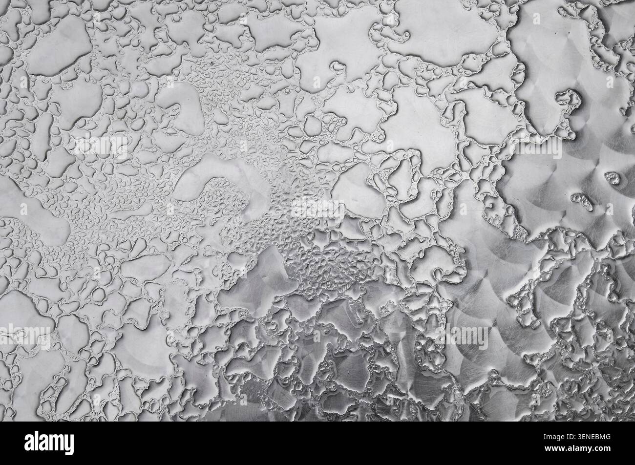 rain drops on patterned metal cafe table top, yorkshire, england Stock Photo
