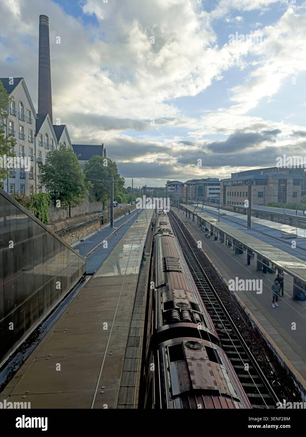 Elevated view over Haymarket station platforms and a train in Edinburgh, where constrained approaches limit rail network capacity. Stock Photo
