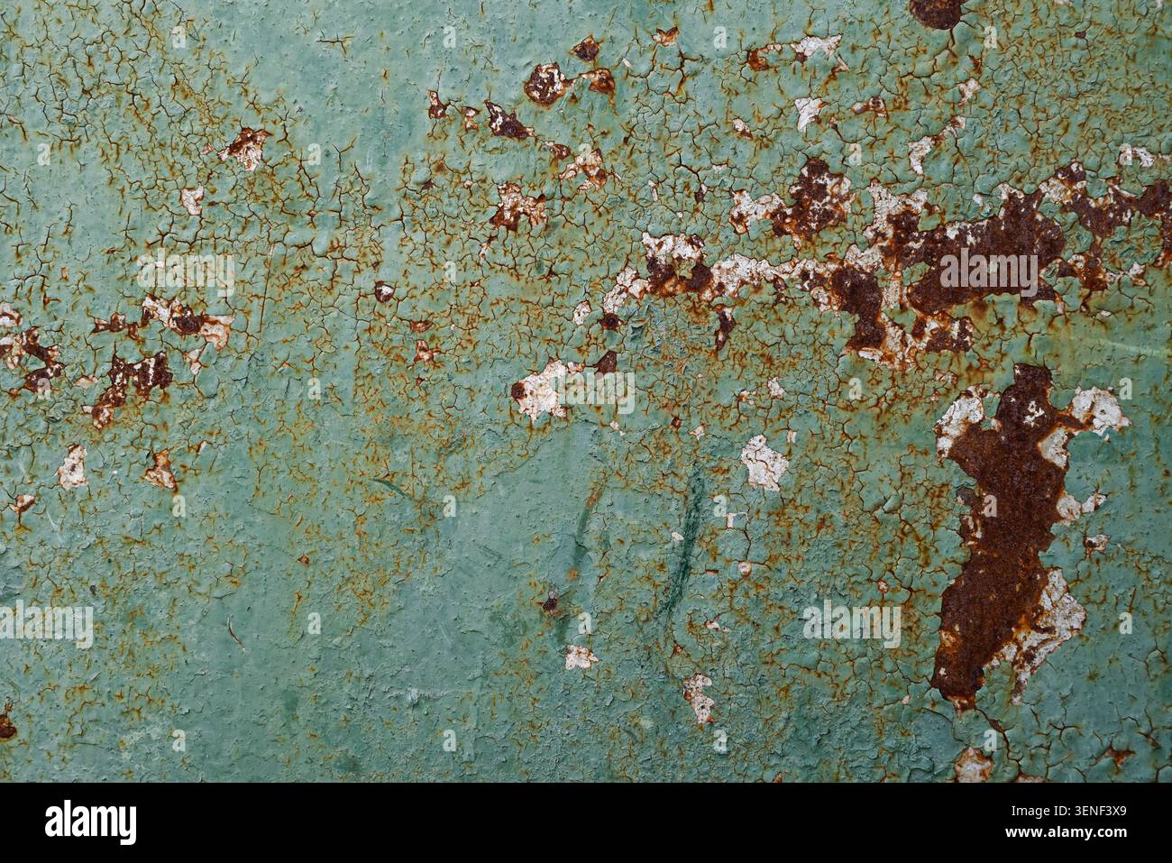 Weathered painted metal texture with rust corrosion and peeling paint. Distressed industrial surface showing age, oxidation and deterioration. Stock Photo