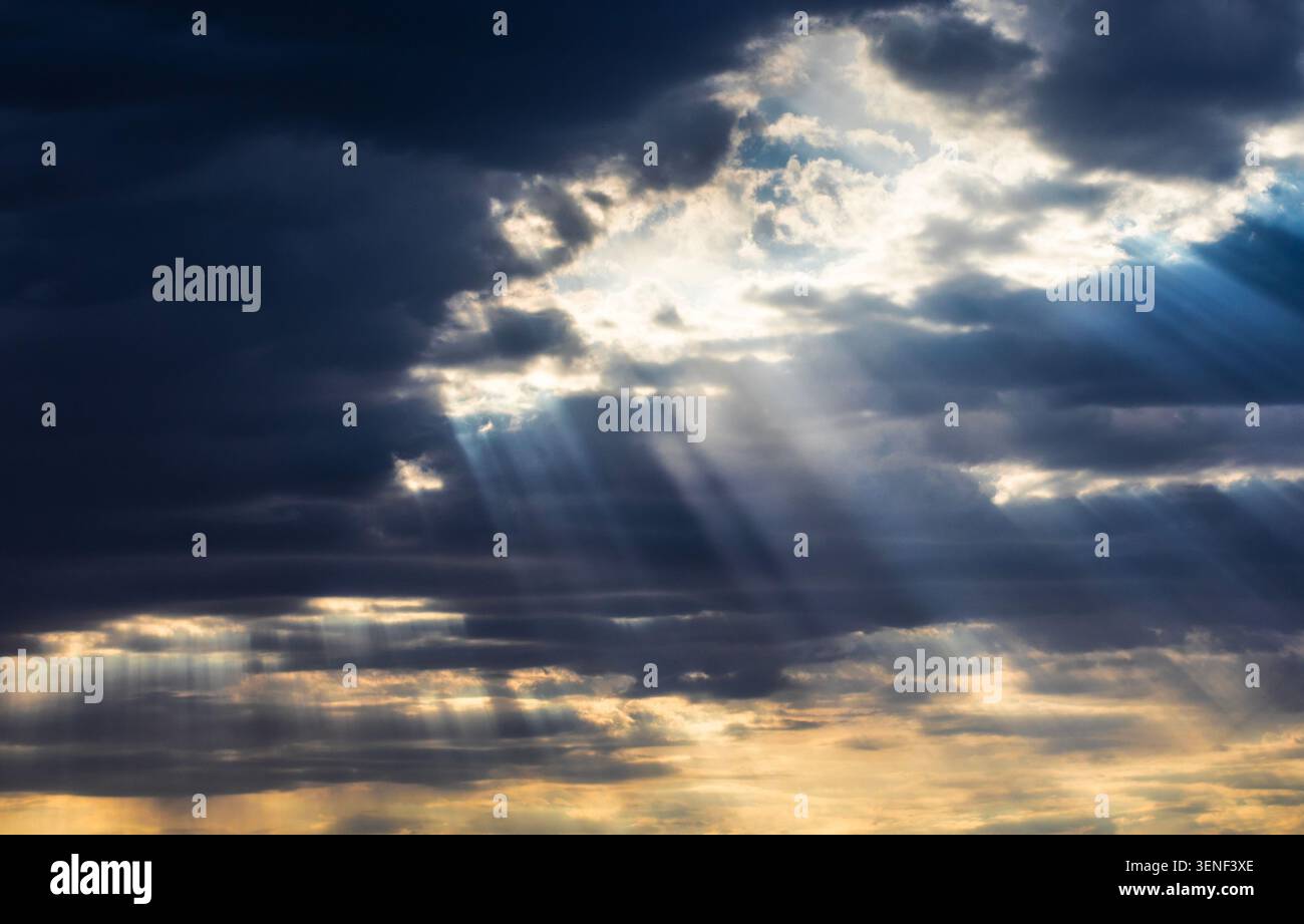 Dozens of sun rays breaking through clouds near Herefored Arizona early in the morning. Stock Photo