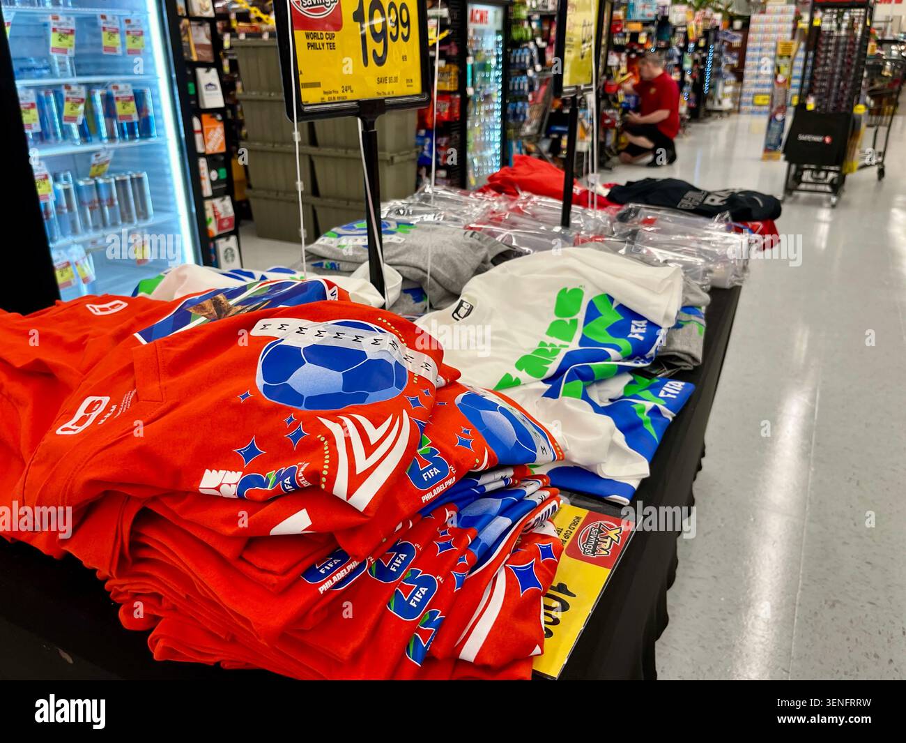 A lonely FIFA World Cup merchandise table stands ignored near a busy supermarket self-checkout line in Philadelphia, PA, June 12, 2026. - Smartphone Captured Stock Image