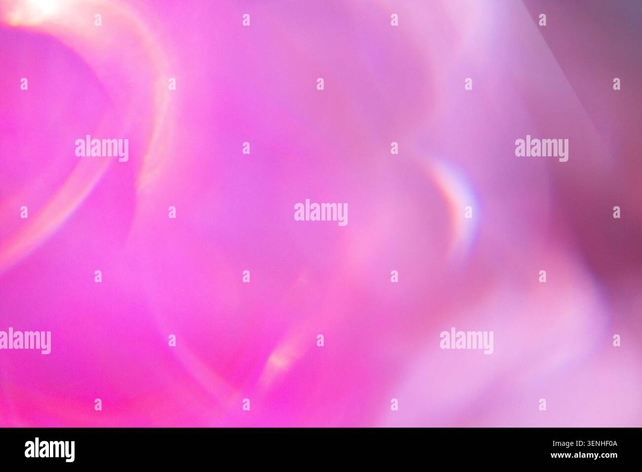 Abstract image showcasing a blurred background with pink and purple colors, highlighted by soft light reflections and circular bokeh effects Stock Photo