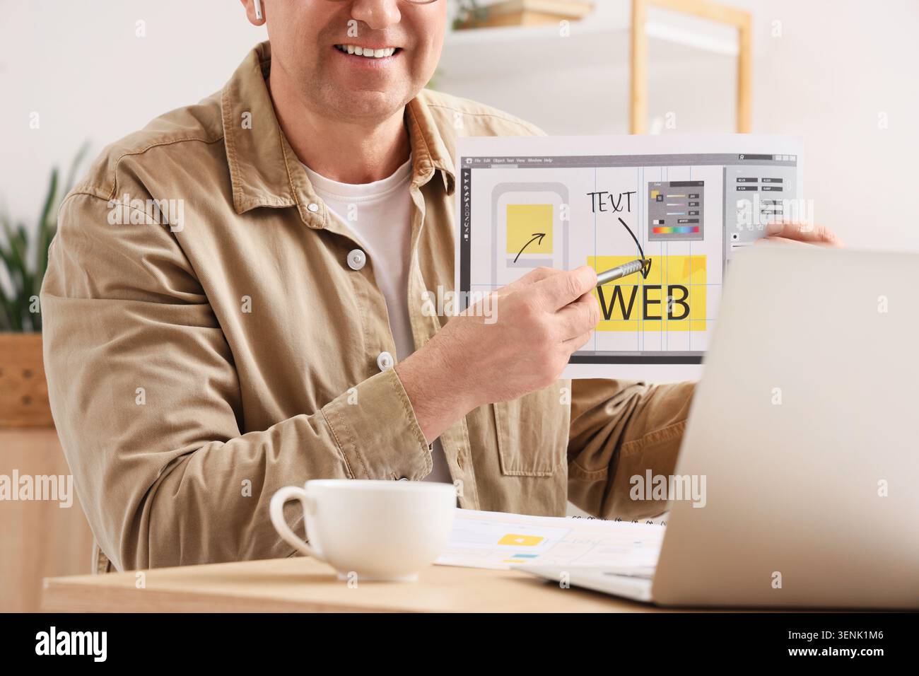 Man presenting web design layout with stylus pen, user interface development and digital marketing strategy Stock Photo