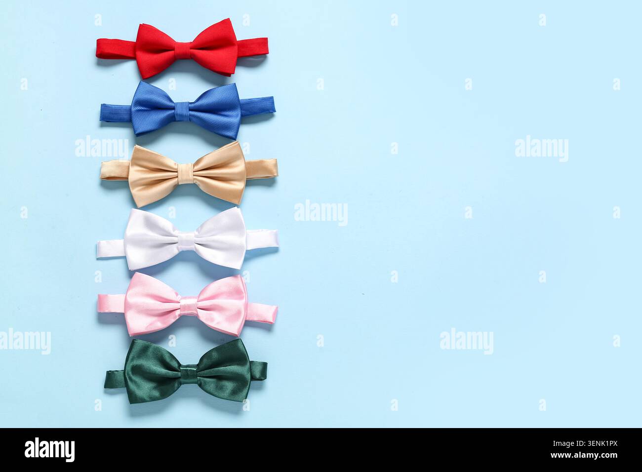 Different stylish bow ties on blue background Stock Photo