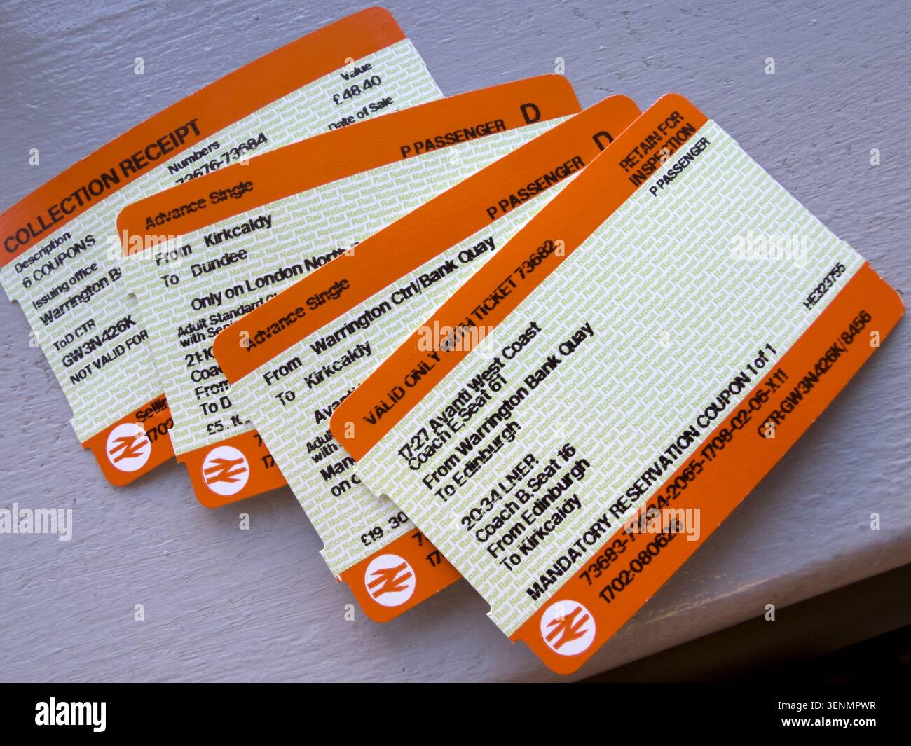 Multiple orange rail tickets show how split ticketing can reduce the train journey cost of travelling between England and Scotland. Stock Photo
