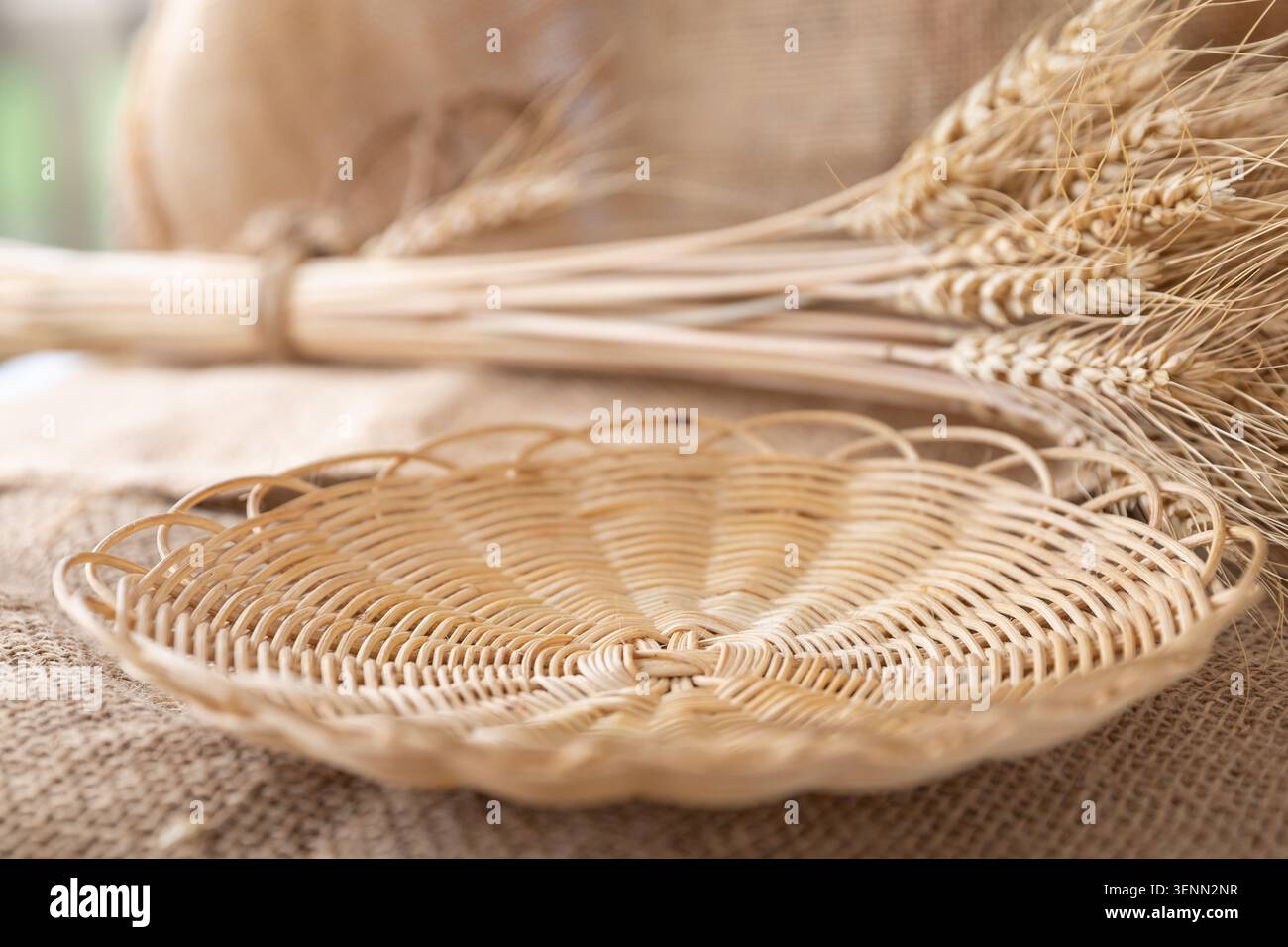 Empty Wicker Bread Basket With Wheat Ears On Rustic Burlap Fabric Stock Photo