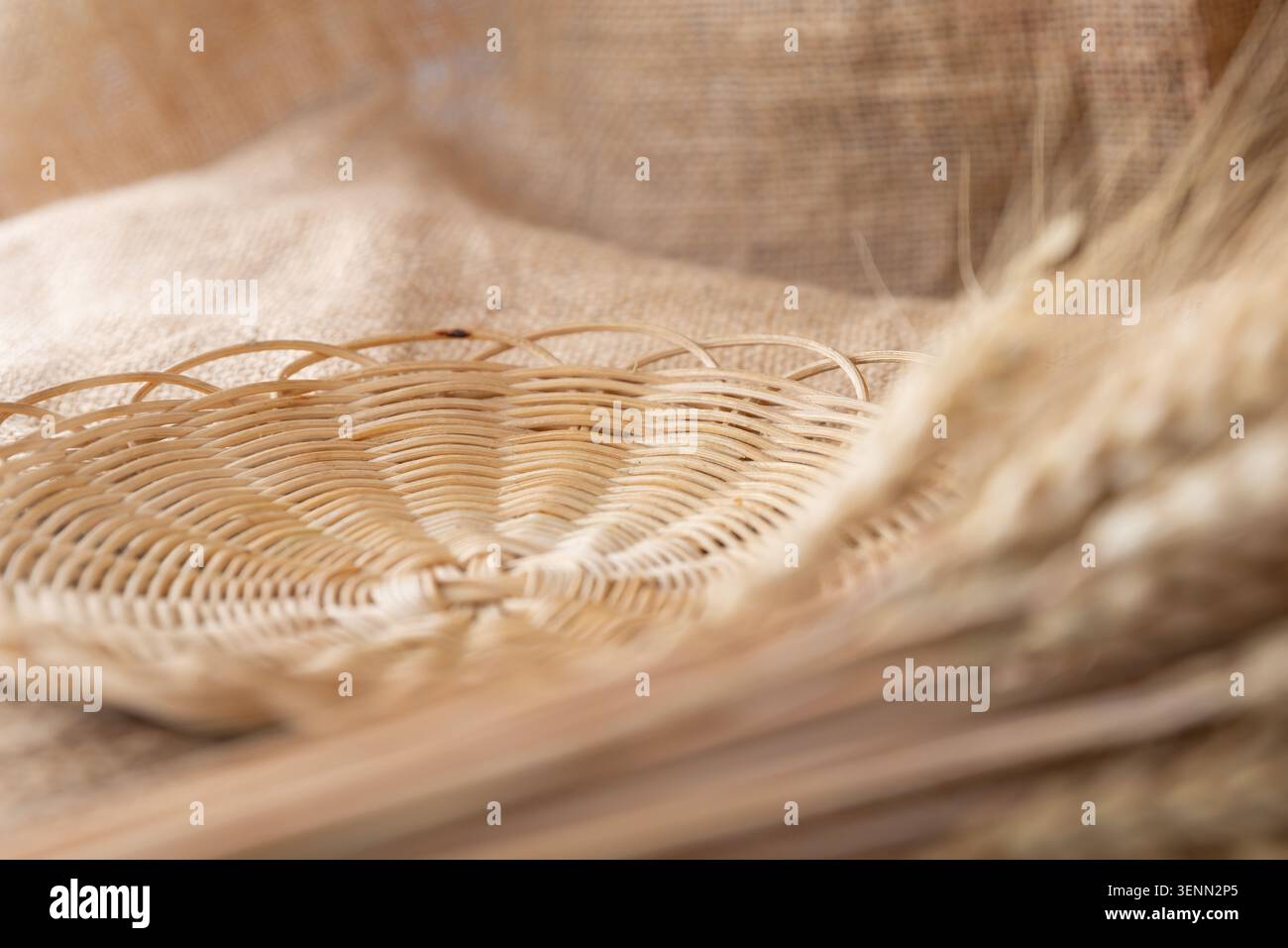 Empty Wicker Bread Basket With Wheat Ears On Rustic Burlap Fabric Stock Photo