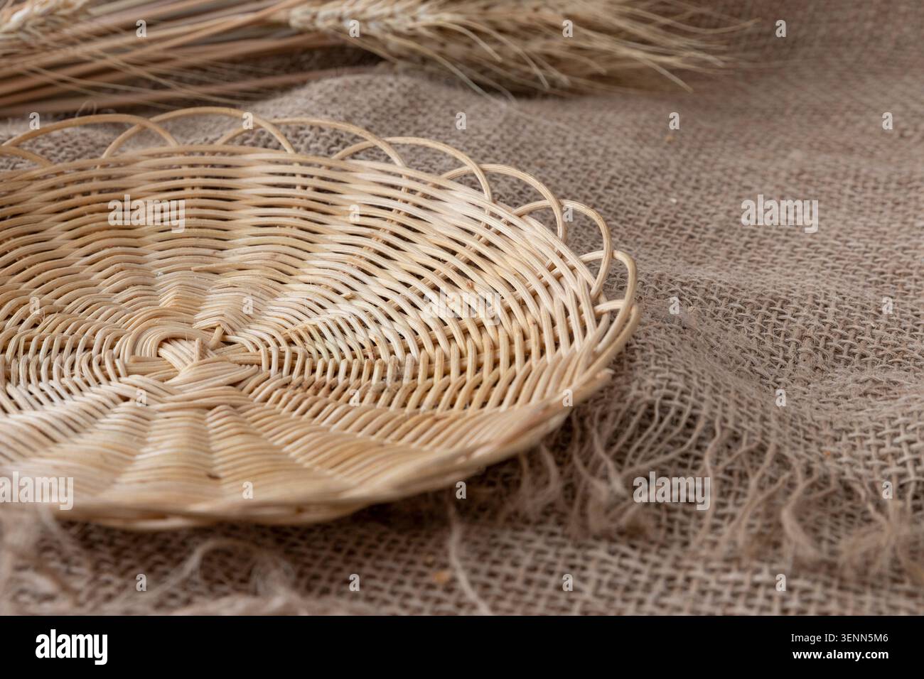 Empty Wicker Bread Tray On Rustic Burlap With Wheat Ears Stock Photo