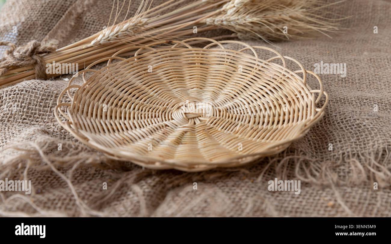 Empty Wicker Bread Tray On Rustic Burlap With Wheat Ears Stock Photo