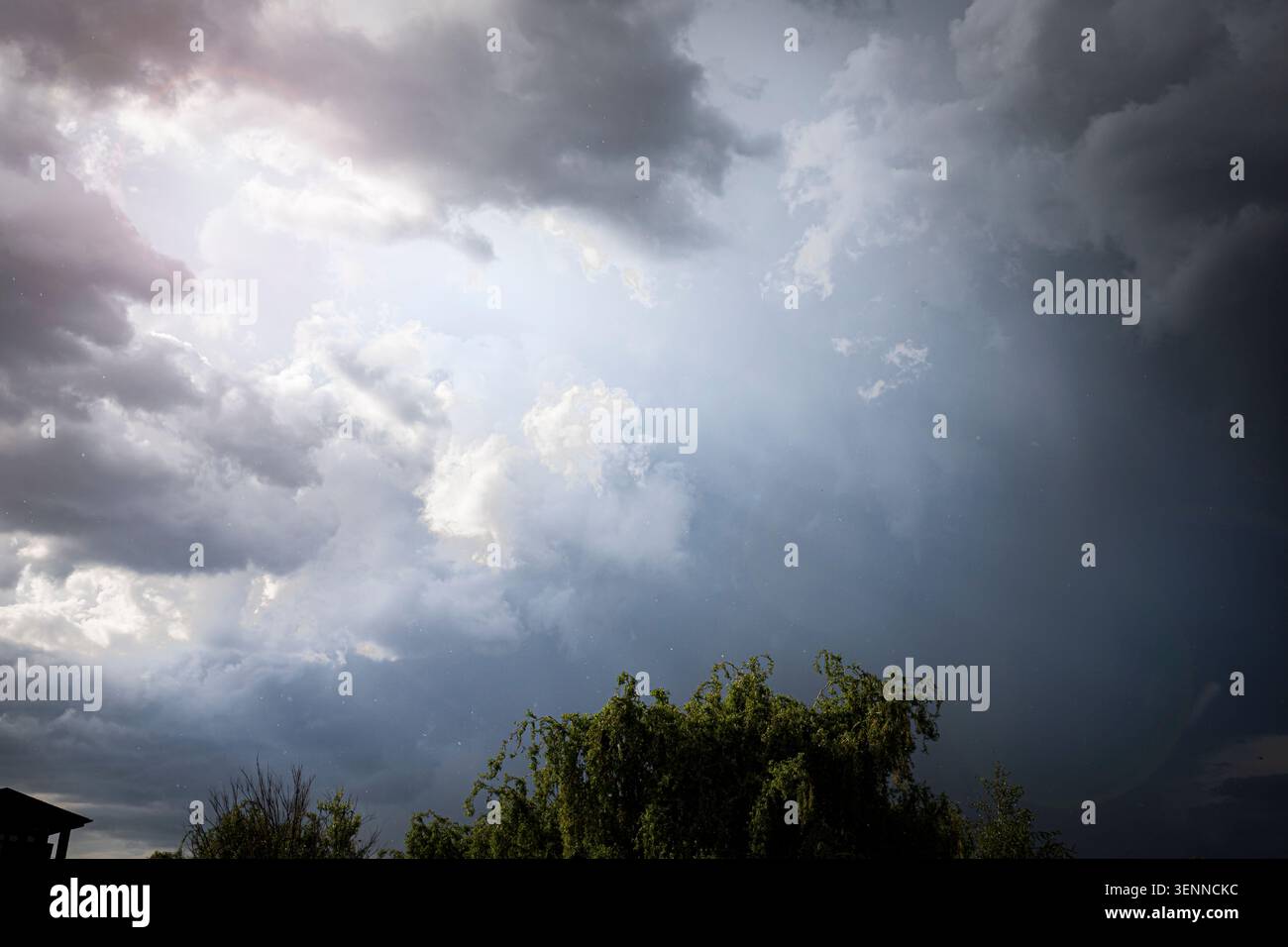 Dramatic Storm Clouds With Sun Rays Breaking Through Before Heavy Rainfall Stock Photo