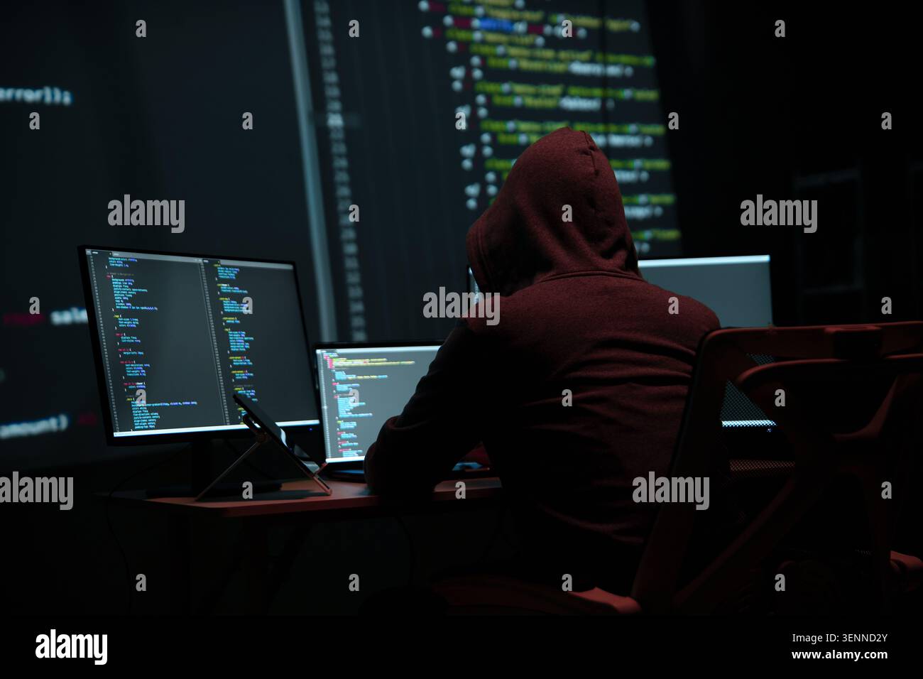 Programmer Hacker Working at Multiple Computer Monitors Stock Photo