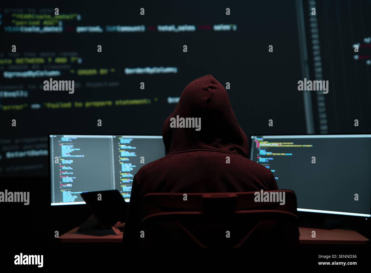 Programmer Hacker Working at Multiple Monitors Stock Photo