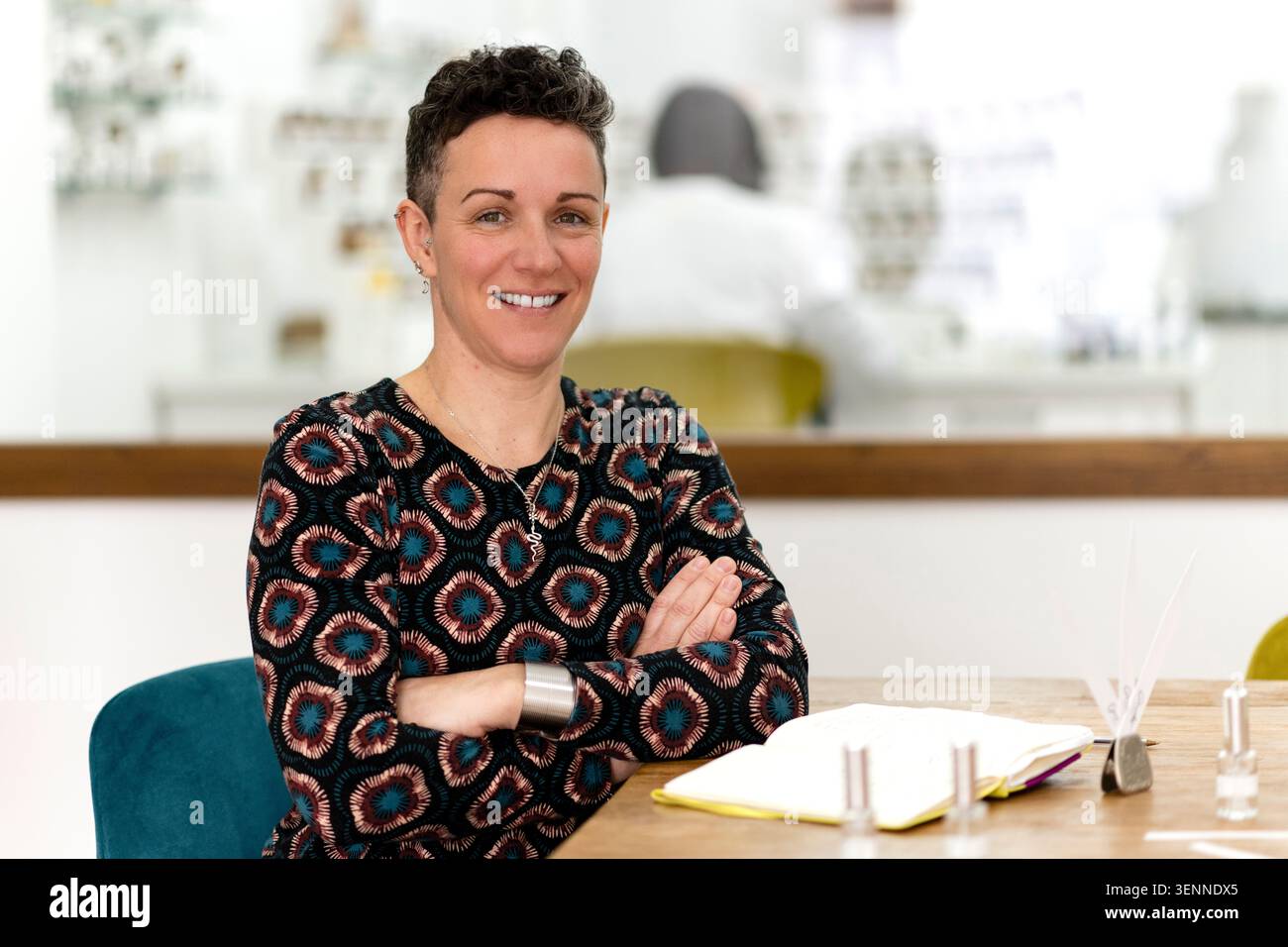 Confident female perfumer smiling in her workshop Stock Photo