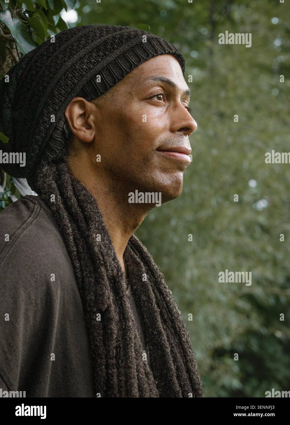 Thoughtful man with dreadlocks looking into the distance Stock Photo