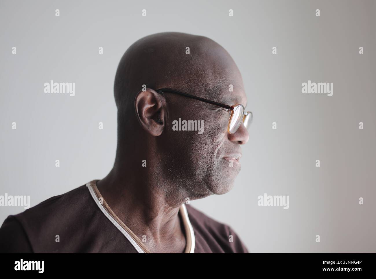 Profile portrait of a senior bald Black man wearing glasses Stock Photo