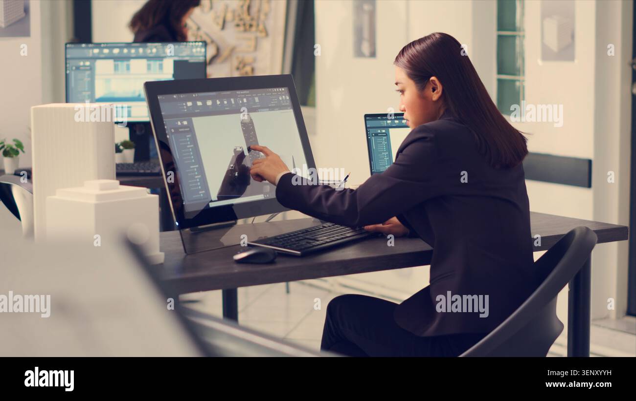 Architect working on building design with graphic software to create layout sketch for architecture project, drawing lines in small business office, designer manufacturing scale, handheld shot. Stock Photo