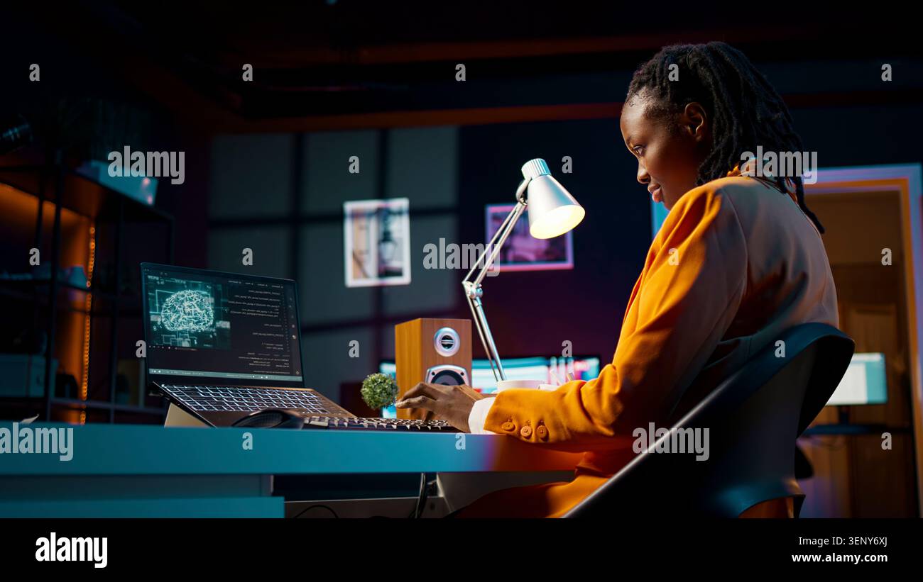 African American system engineer using AI system to write computer program code, HTML terminal window, woman works with deep learning algorithms, artificial intelligence neural networks. Stock Photo