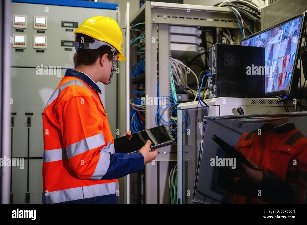 IT technician holding tablet inspecting server rack network data center, maintaining telecommunication server room, checking cables mainframe cabinet, Stock Photo