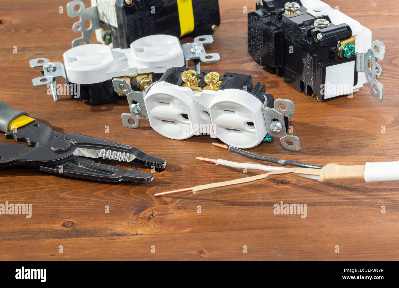 Electrical outlet, screwdriver and wire stripper tools on white background Stock Photo