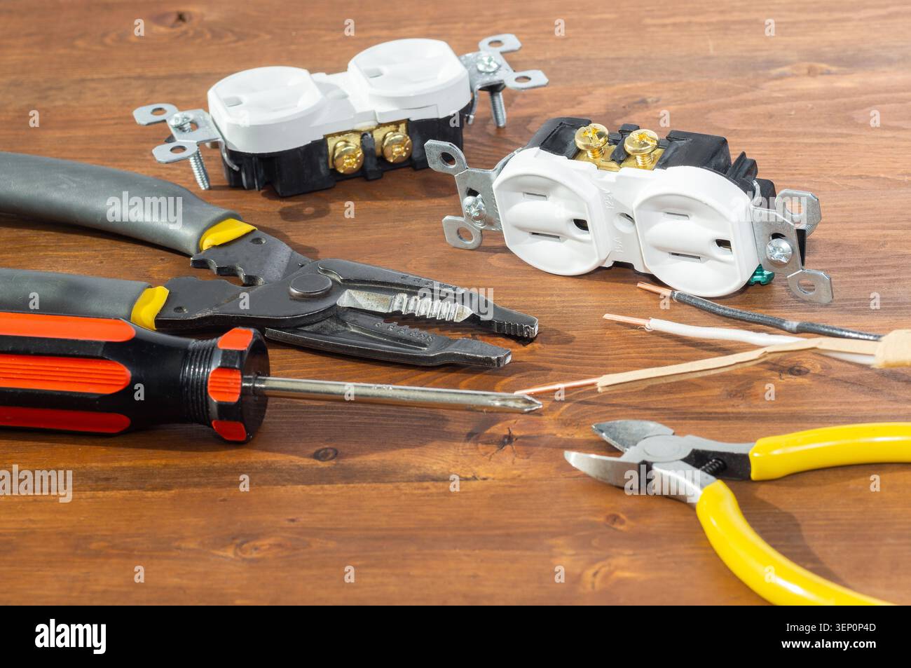 Electrical outlet, screwdriver and wire stripper tools on white background Stock Photo
