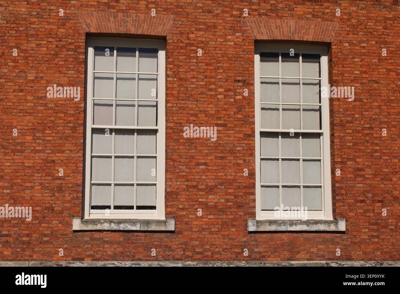 Single wooden multi framed window in a red brick wall Stock Photo