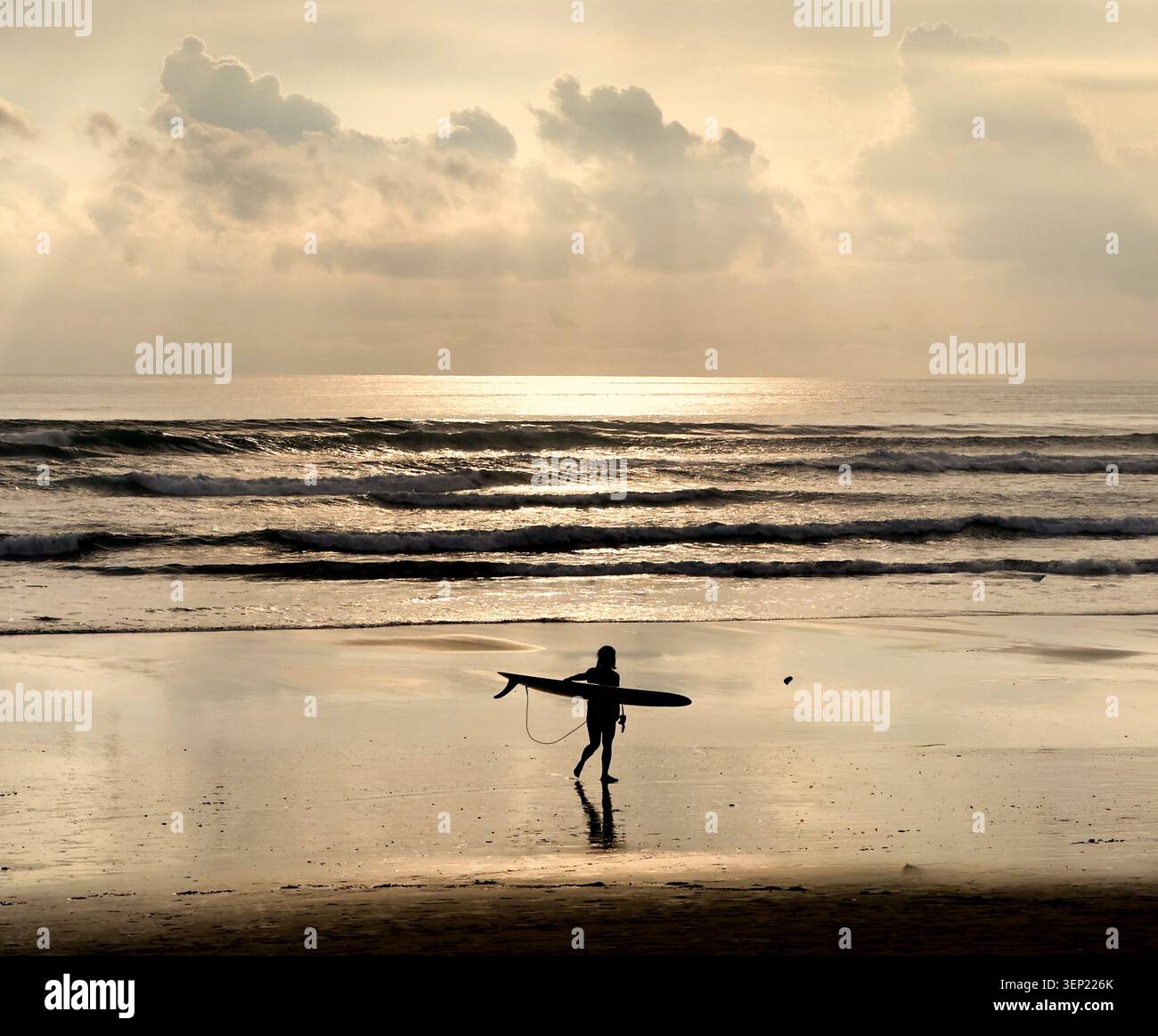 Surfer returning from day in the surf in Bali, Indonesia - Smartphone Captured Stock Image