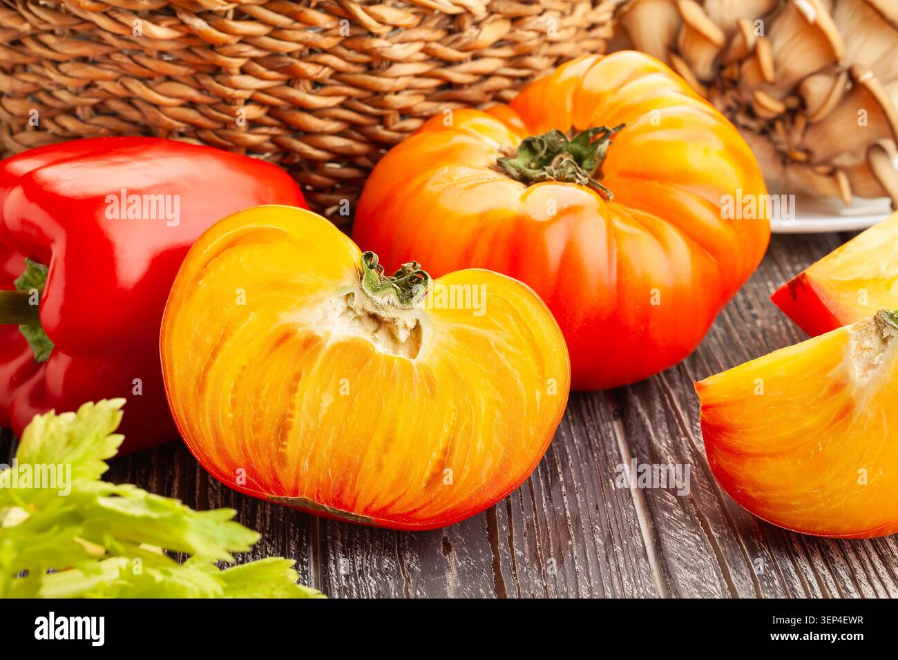 sliced tomato on wood background Stock Photo